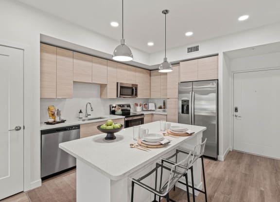 a kitchen with a large island and stainless steel appliances at Altis Grand Kendall, Miami, FL 33186