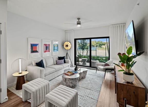 a living room with white furniture and a large window at Altis Grand Kendall, Miami