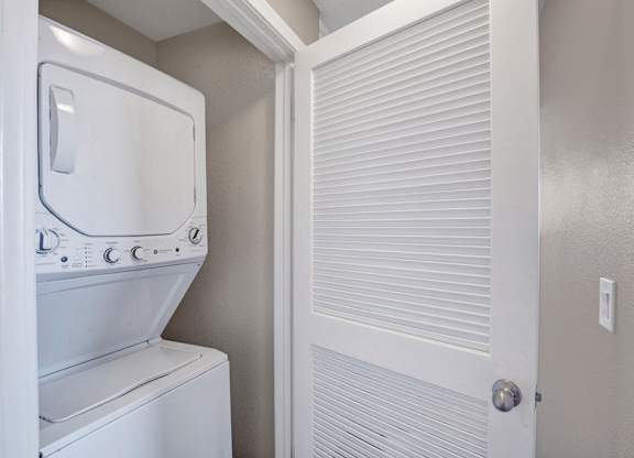 A white washing machine and dryer in a small laundry room.