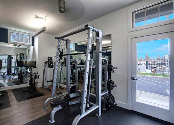 A gym with a view of a street outside the window.