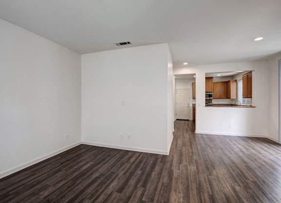 A room with wooden floors and white walls.