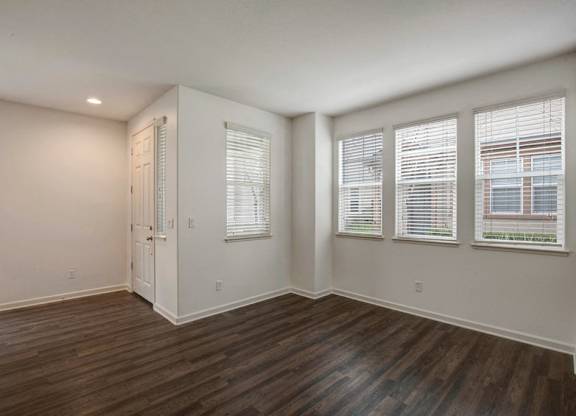 A room with wooden floors and white walls.