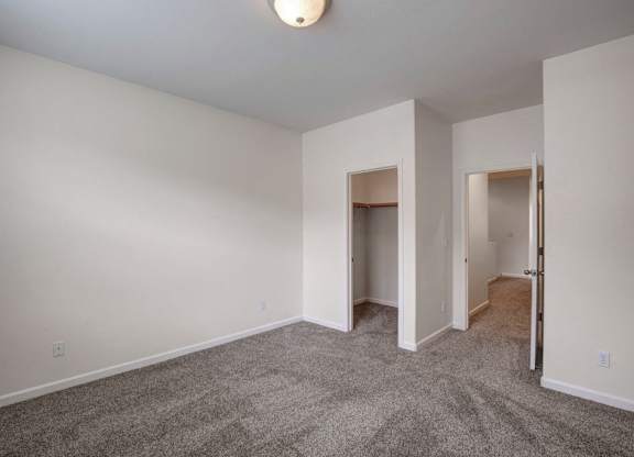 A room with carpeted floor and white walls.