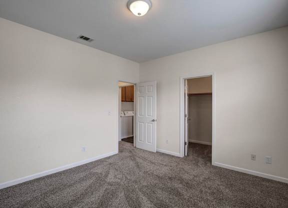 A room with a carpeted floor and a ceiling light.