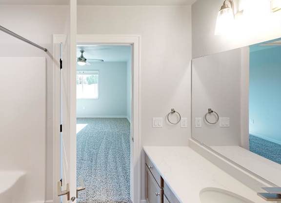 A bathroom with a white tub and a white sink.