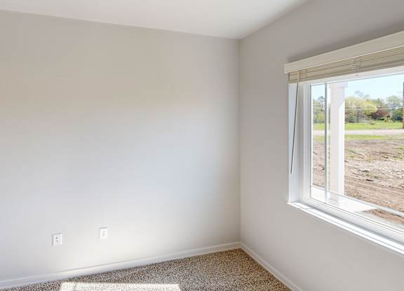 A room with a window overlooking a construction site.