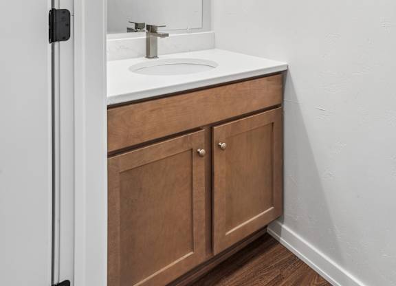 A bathroom with a sink and a mirror.