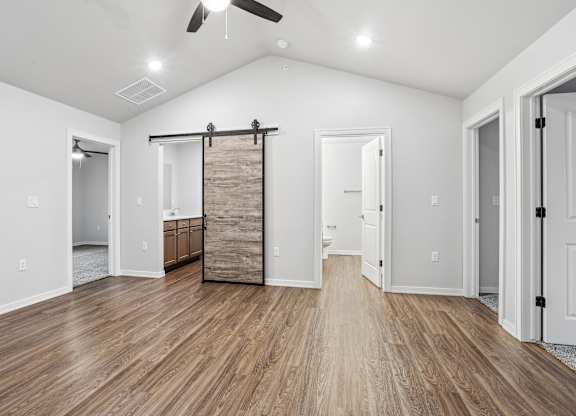 A room with a sliding door and hardwood floors.