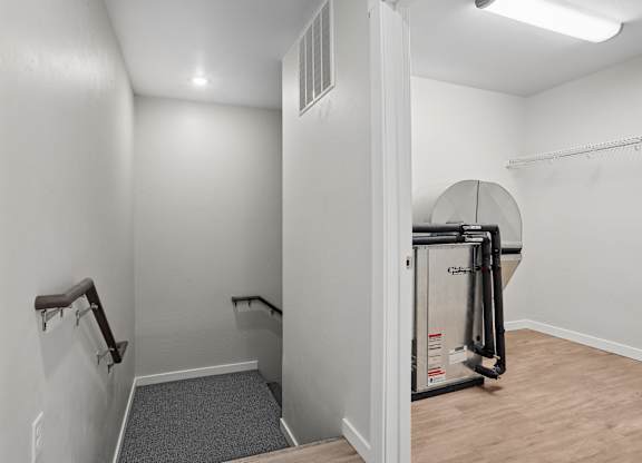 A room with a treadmill and a staircase.