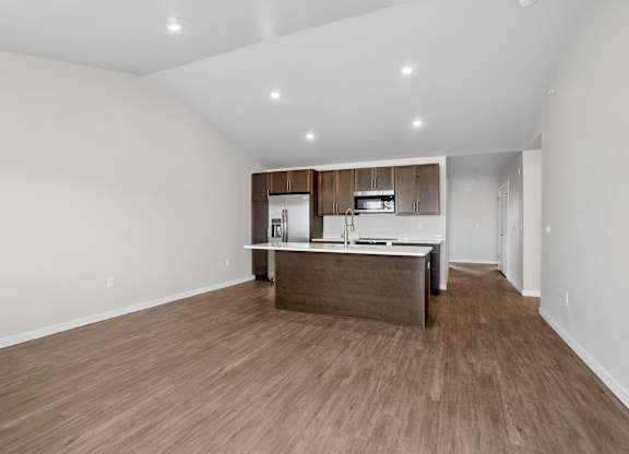 A kitchen with wooden floors and white walls.