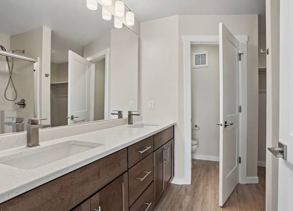 A bathroom with a sink, mirror, and wooden cabinets.