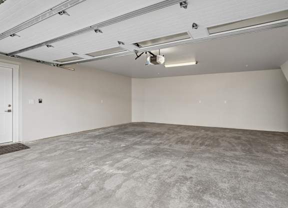 Empty room with grey carpet and white walls.