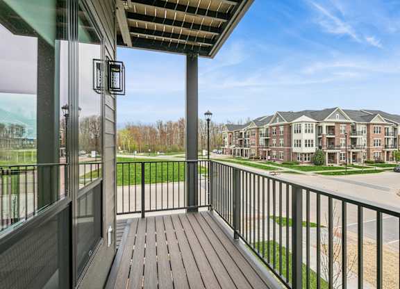A balcony with a view of apartment buildings.