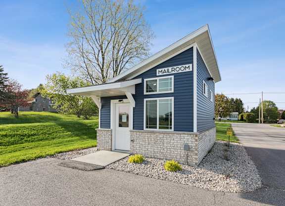 A small blue building with the words "MAILROOM" on the front.
