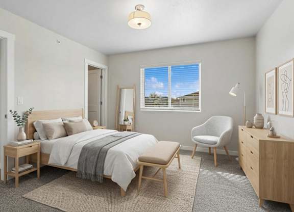 A bedroom with a bed, chair, and dresser.