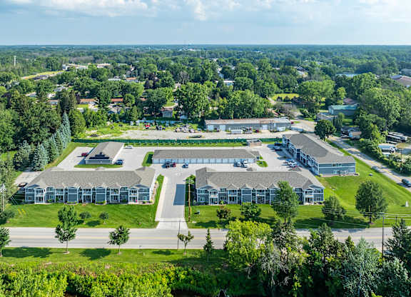 an aerial view of a building surrounded by grass and trees