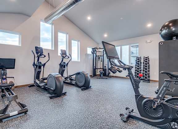A spacious gym with a variety of exercise equipment.