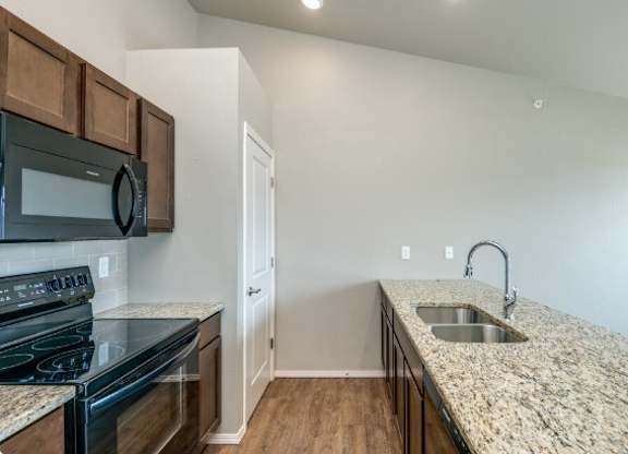 Kitchen with Granite Countertops and Black Appliances