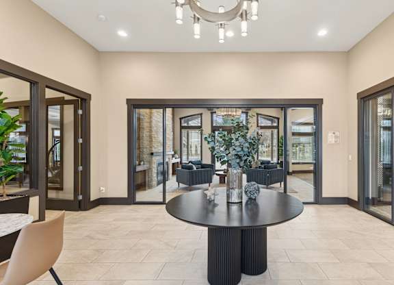 A modern dining room with a round table and chairs.