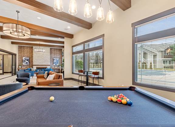 A pool table with a white ball and some colorful balls on it.