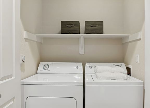 A small laundry room with a washer and dryer.