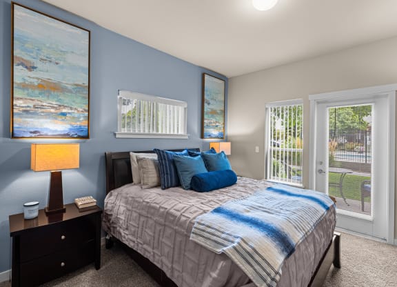 a bedroom with a bed and two windows