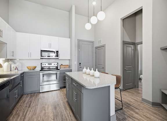 A modern kitchen with a stove top oven and a microwave.