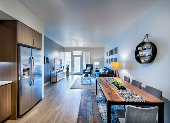 A modern kitchen with a wooden table and chairs.