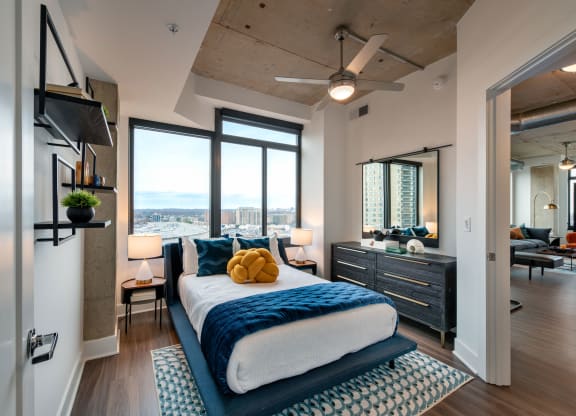 a bedroom with a bed and a view of the city