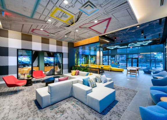 a rendering of a lobby with blue couches and chairs