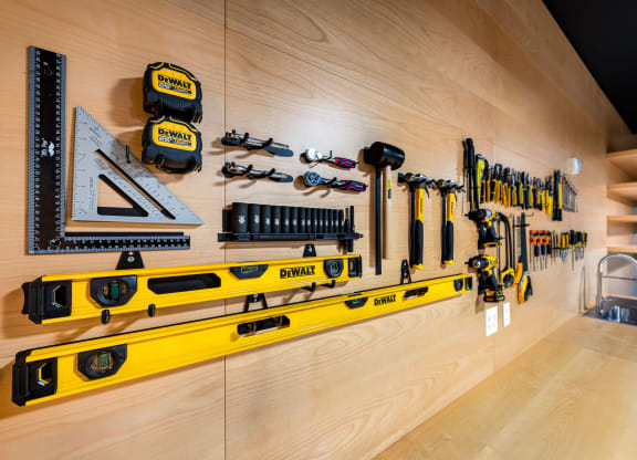a wall of tools hangs on the wall of a workshop