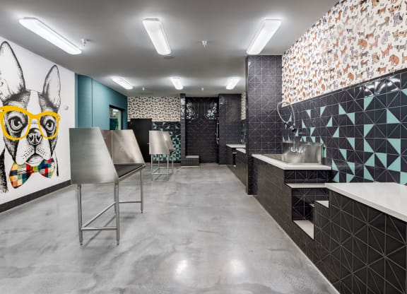 a public restroom with a dog painting on the wall