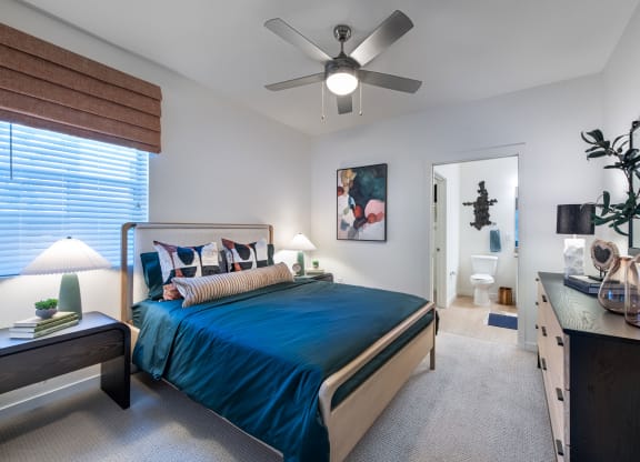 a bedroom with a bed and a ceiling fan