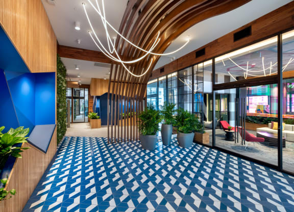 a lobby with a blue and white tile floor and glass doors