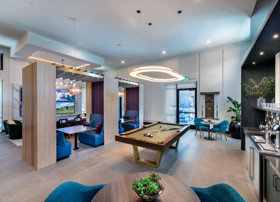 a lounge area with a pool table and a bar