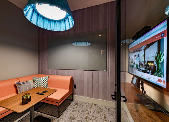 a room with a couch and a table and a television