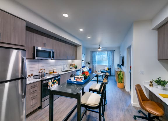 private kitchen with island and stainless steel appliances at the reserve at walnut creek apartments