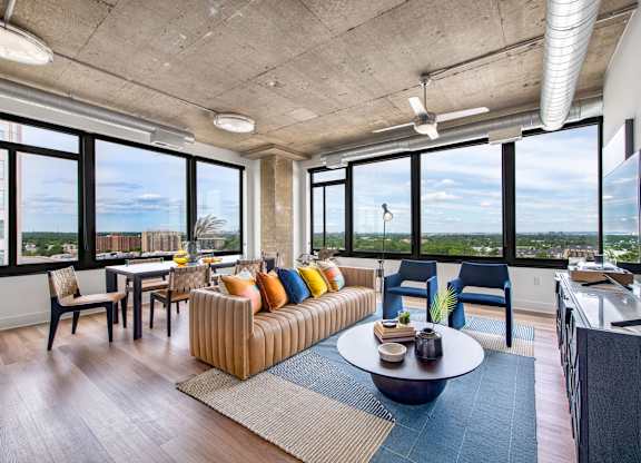 A living room with a couch, chairs, and a coffee table.