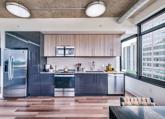 A modern kitchen with wooden cabinets and stainless steel appliances.
