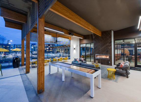 Corsair Apartments Patio Area with Game Table and Fireplace