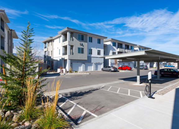 an empty parking lot in front of an apartment building
