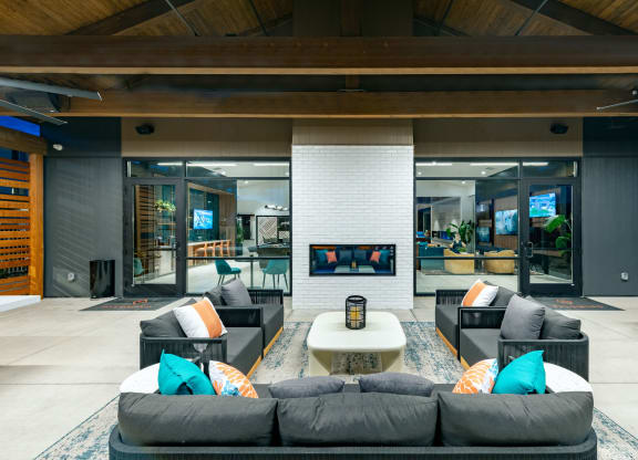 a living room with couches and a coffee table and a fireplace