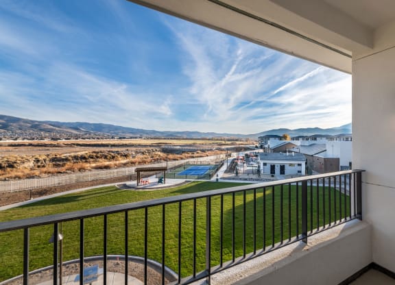 a balcony with a view of a building and a pool