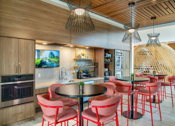 a dining area with chairs and tables and a kitchen