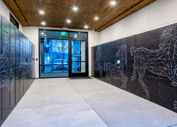 the lobby of a building with a door and a wall with a graphic on it