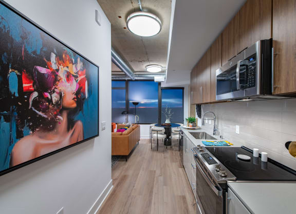 a kitchen and dining room with a large painting on the wall