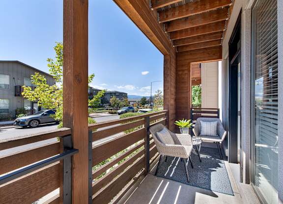 A balcony with a chair and a table.