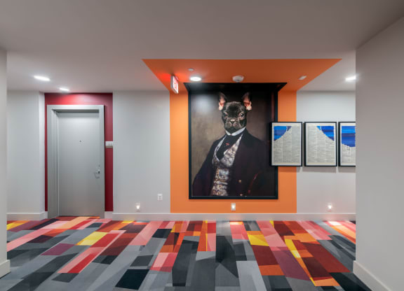 a painting of a dog on a wall in a room