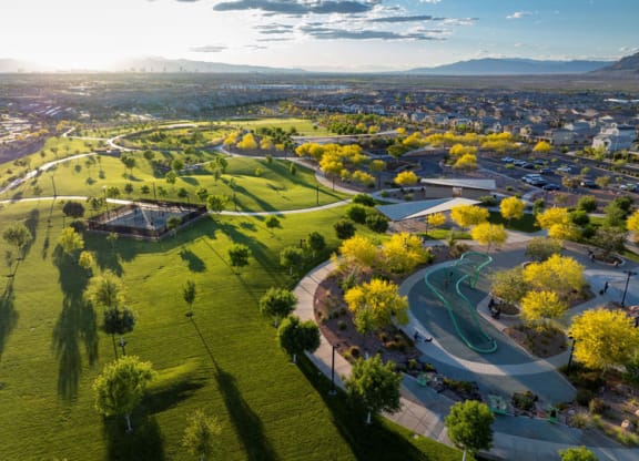an aerial view of a park with the city in the background