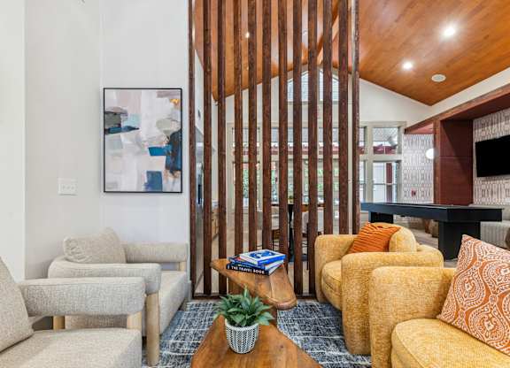 A living room with a wooden slat wall and a couch.